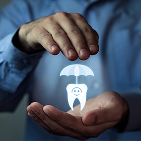 Hands holding an animated tooth under an umbrella