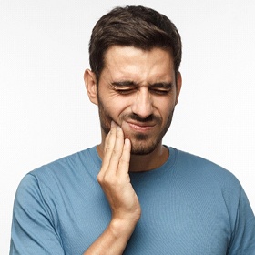 Man in grey with tooth pain