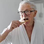 Dentures patient in Goode brushing their remaining teeth