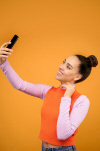 Woman taking a selfie with a cell phone