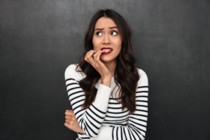 Woman nervously biting her nails